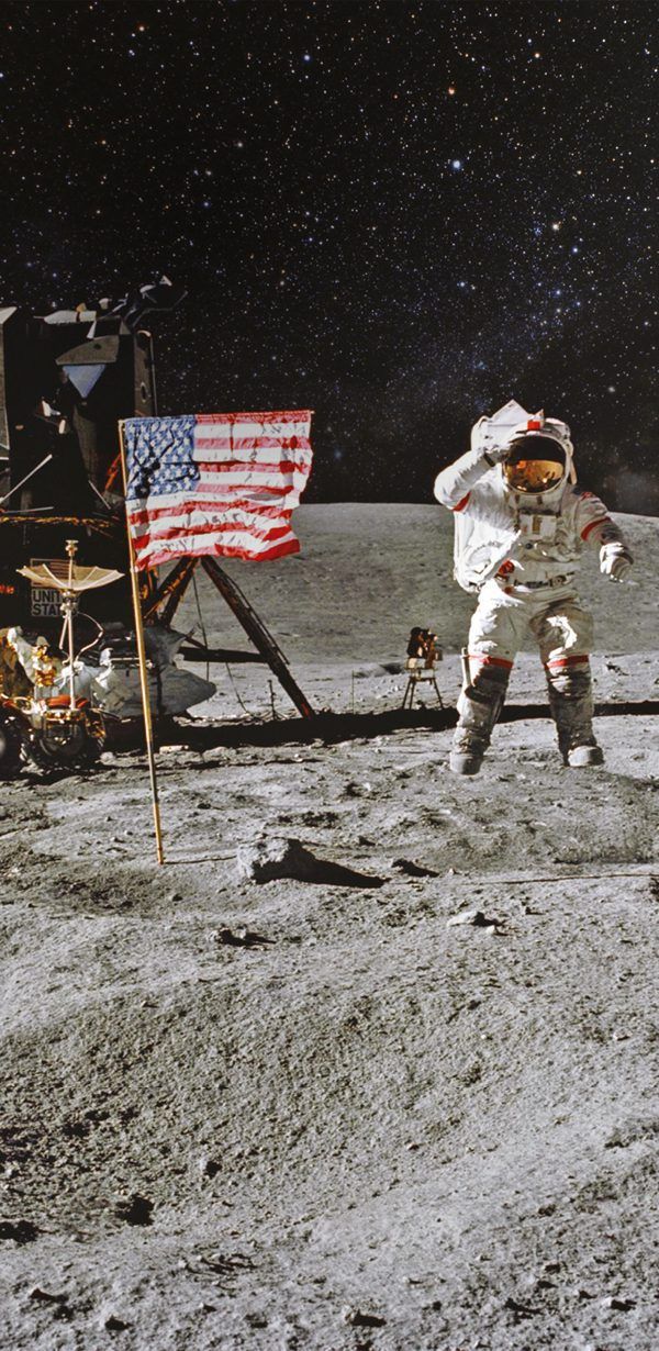 Astronaut beside a lunar module and United States flag on the Moon