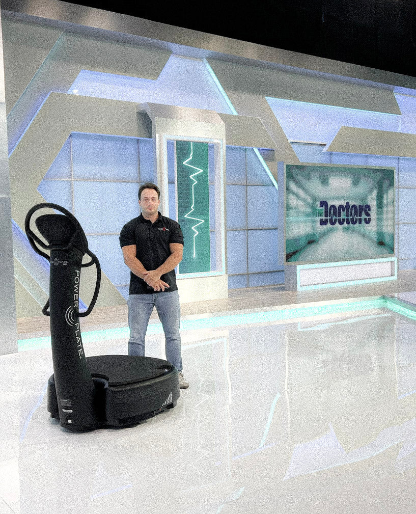 Floran Giezen beside a Power Plate on The Doctors television set